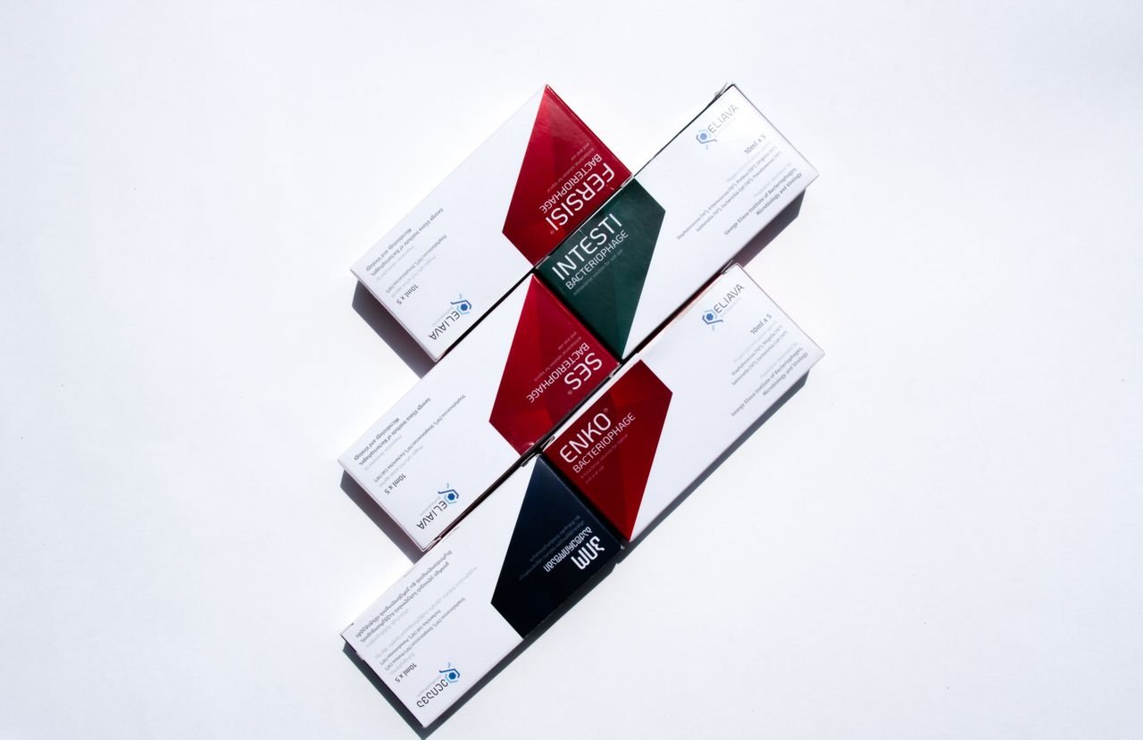 Close-up of various pharmaceutical packages arranged on a white surface.